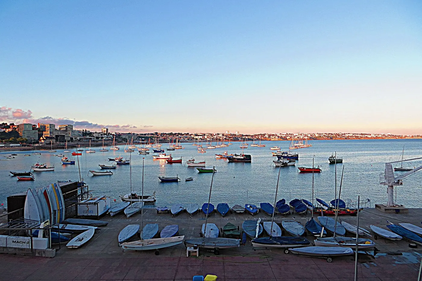 Cascais bay at dusk, boats moored along the Portuguese riviera